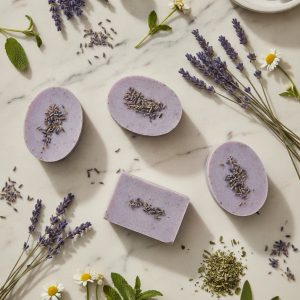 Aida Lavender Soap composition flat lay with dried lavender and botanicals